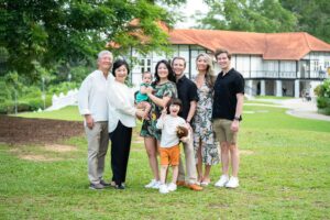 Family with grandparents and parents hugging their children during a family outdoor photoshoot in Singapore, Botanic Gardens. Credit: White Room Studio Pte Ltd