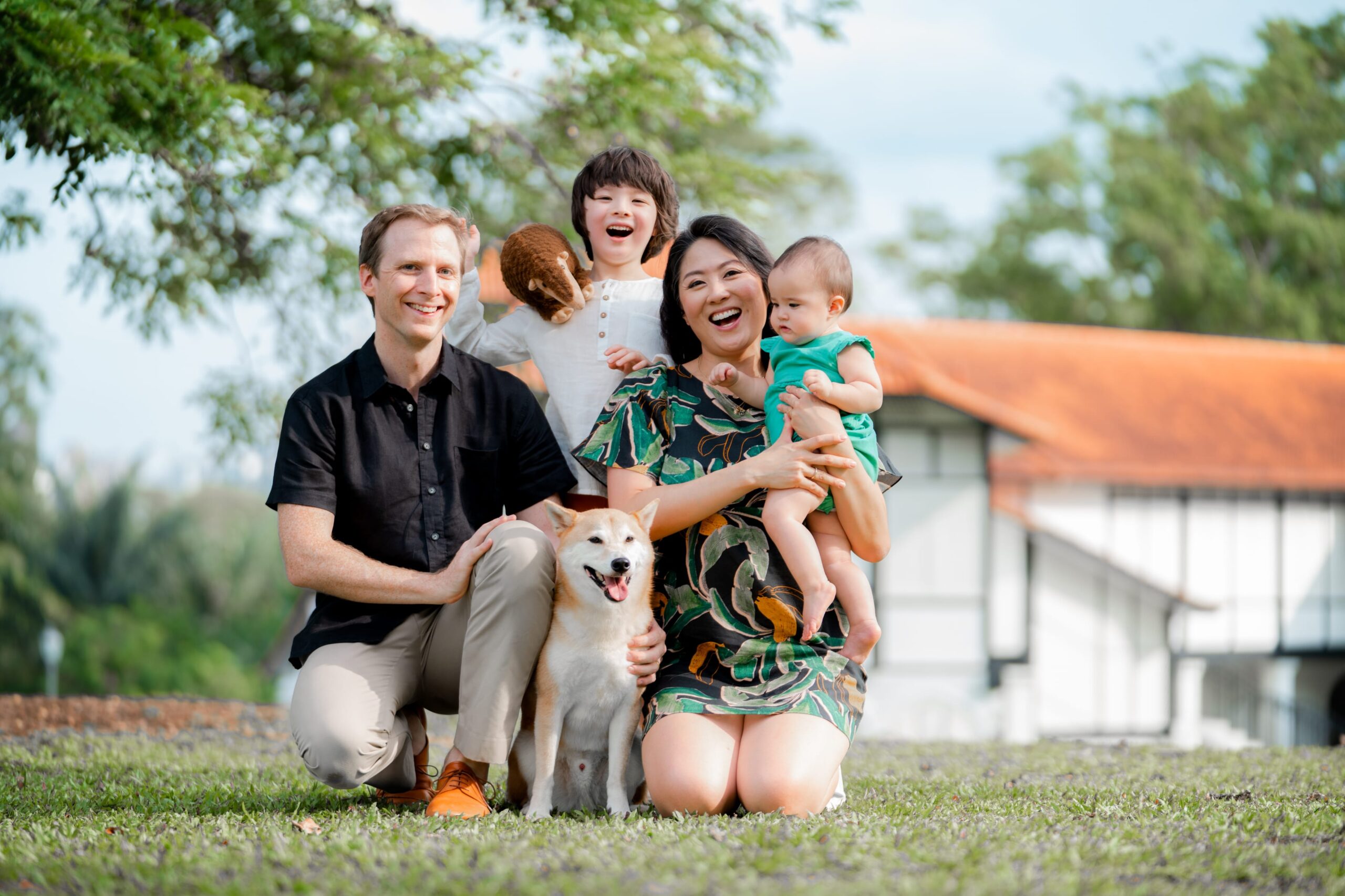 Family with parents and their children and pet dog during a family outdoor photoshoot in Singapore, Botanic Gardens. Credit: White Room Studio Pte Ltd
