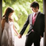Bridal Photography Singapore bride and groom holding hands at door frame natural light indoor photoshoot