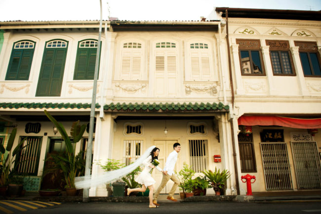 Bridal Photography Singapore bride and groom running at shop houses outdoor photoshoot