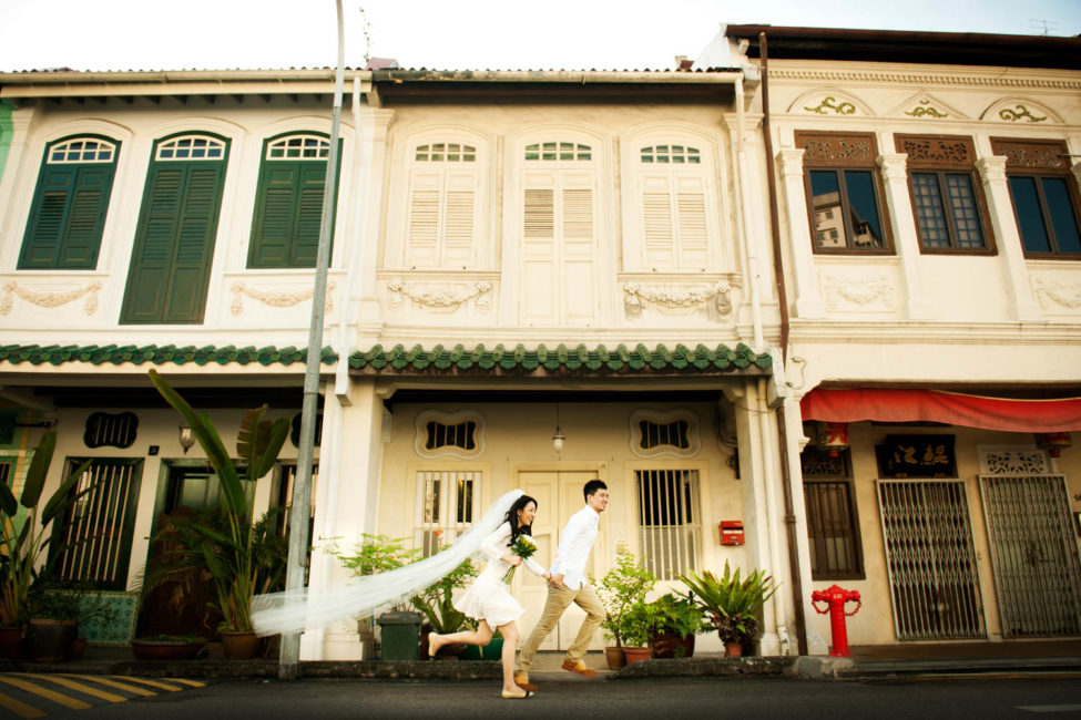 Bridal Photography Singapore bride and groom running at shop houses outdoor photoshoot