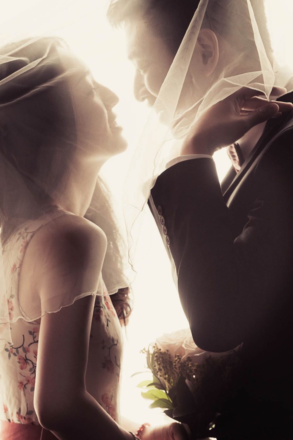 Bridal Photography Singapore bride and groom under wedding veil looking at each other