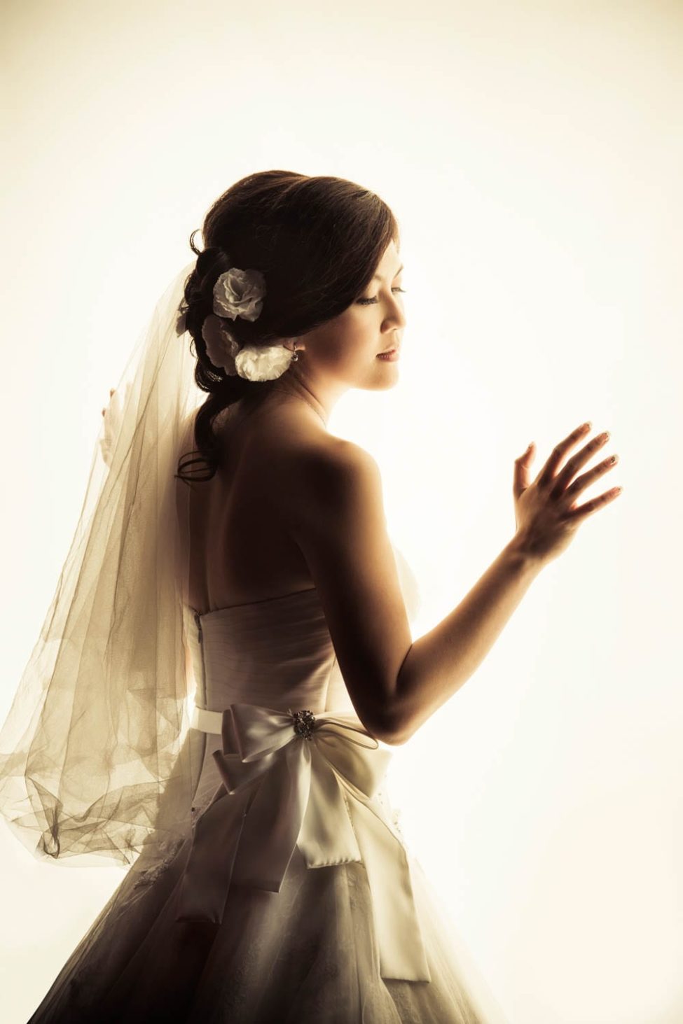 Bridal Photography Singapore bride in wedding dress back side view portrait with white light
