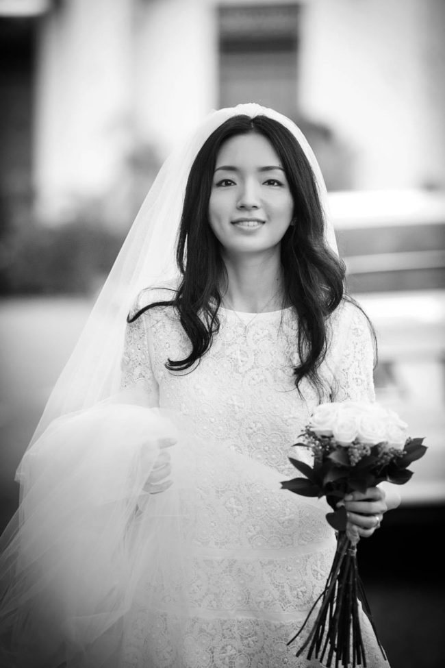Bridal Photography Singapore bride smiling and holding flower bouquet outdoor black and white portrait