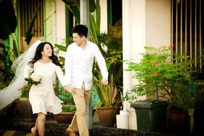 Bridal Photoshoot Singapore bride and groom holding hands smiling and walking outdoors photography