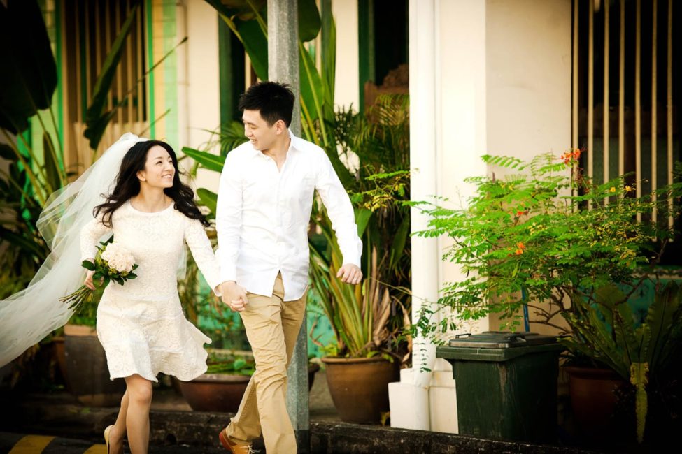 Bridal Photoshoot Singapore bride and groom holding hands smiling and walking outdoors photography
