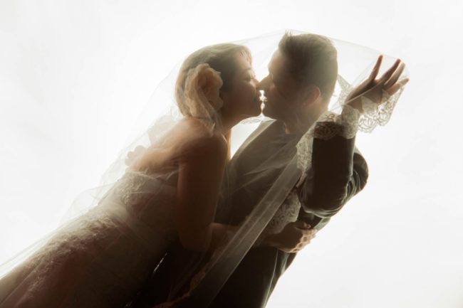 Bridal Photoshoot Singapore bride and groom intimate face to face under wedding veil natural light photography