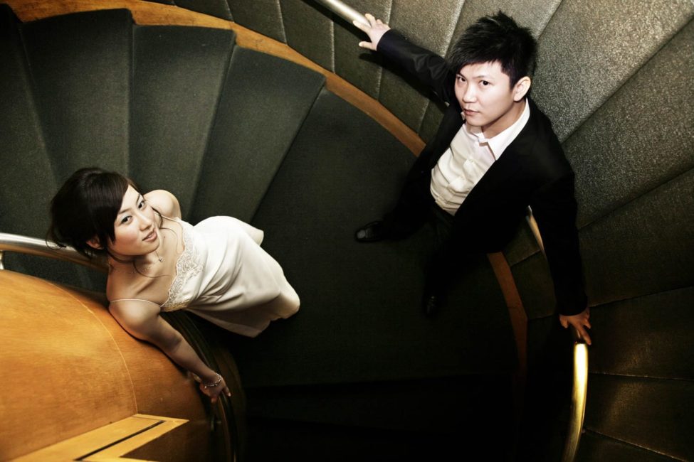 Bridal Photoshoot Singapore bride and groom posing on spiral staircase indoor photography