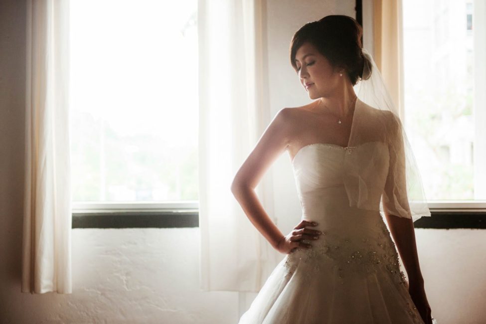 Bridal Photoshoot Singapore bride in wedding dress hand on hip natural light portrait photography