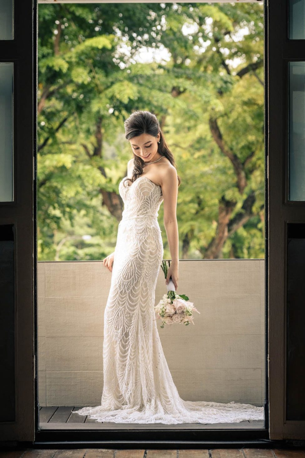Bridal Photoshoot Singapore bride in wedding dress holding flower bouquet natural landscape background
