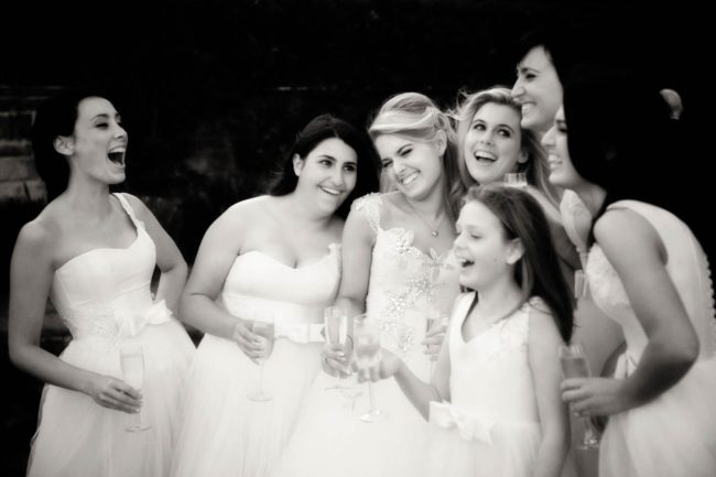Bridal Photoshoot Singapore bride with bridesmaids candid smiling laughing group photo black and white portrait photography