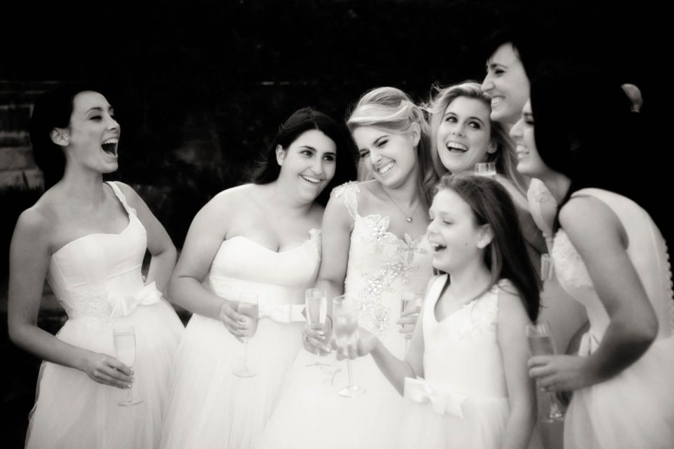 Bridal Photoshoot Singapore bride with bridesmaids candid smiling laughing group photo black and white portrait photography