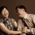 Couple Photography Singapore elderly man and woman holding hands and laughing candid photoshoot sepia tone portrait