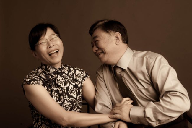 Couple Photography Singapore elderly man and woman holding hands and laughing candid photoshoot sepia tone portrait