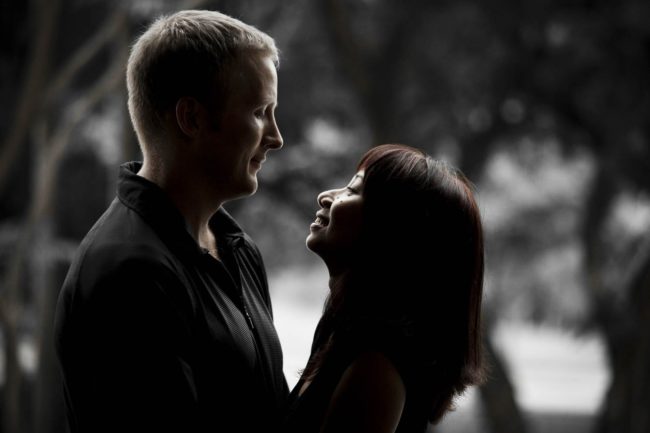 Couple Photography Singapore man and woman couple holding and looking at each other black and white portrait