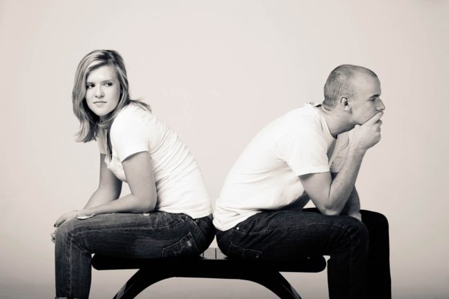 Couple Photography Singapore man and woman in white tshirts sitting facing away from each other black and white portrait photography