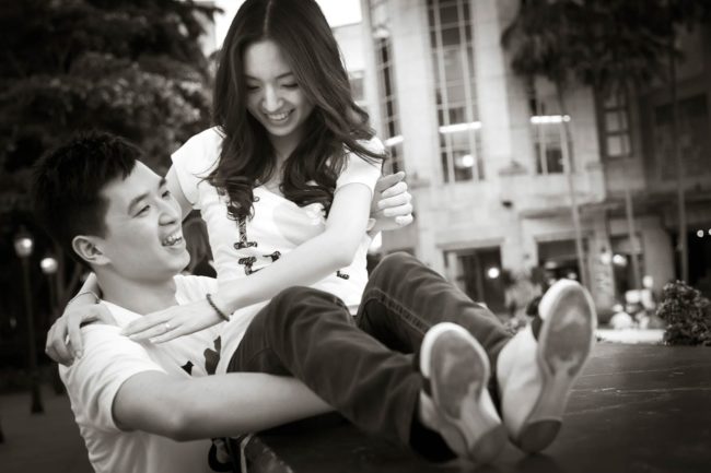 Couple Photography Singapore smiling man carrying woman outdoor casual photoshoot black and white photography