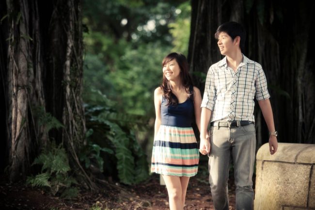 Couple Photoshoot Singapore man and woman couple holding hands while walking at park outdoor photography