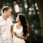 Couple Photoshoot Singapore outdoor photography couple in white looking at each other and smiling