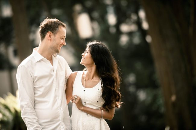 Couple Photoshoot Singapore outdoor photography couple in white looking at each other and smiling
