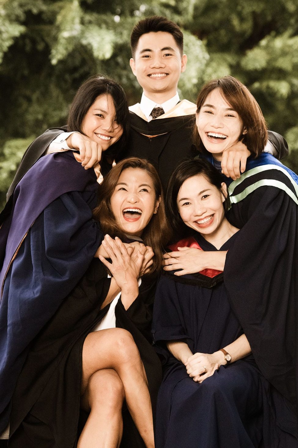 Graduation Photoshoot Singapore candid friends hugging and laughing fun photoshoot with nature landscape background