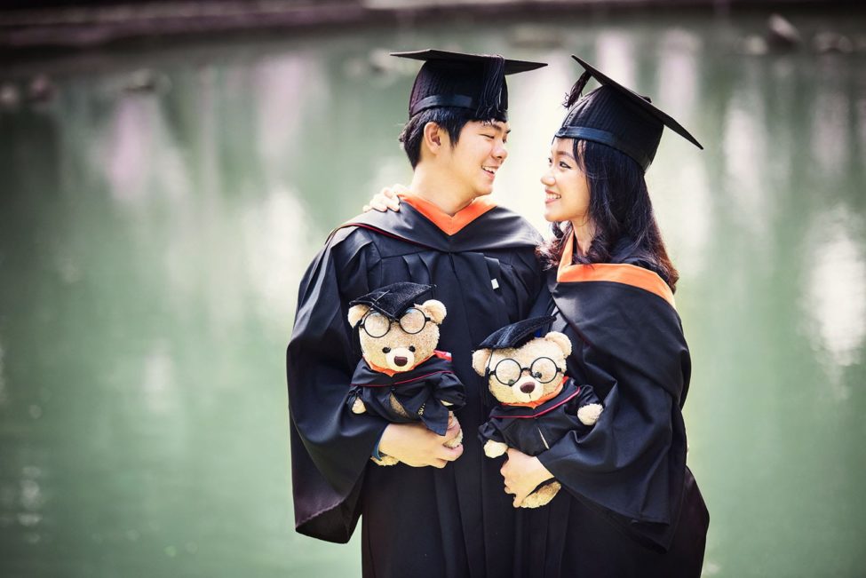 Graduation Pictures Singapore graduate couple holding bear plush toys outdoor photoshoot