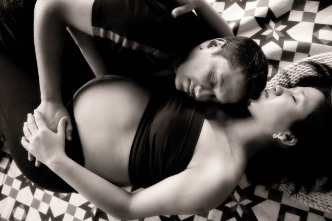 Maternity Photography Singapore intimate boudoir photoshoot hugging husband and pregnant wife with closed eyes