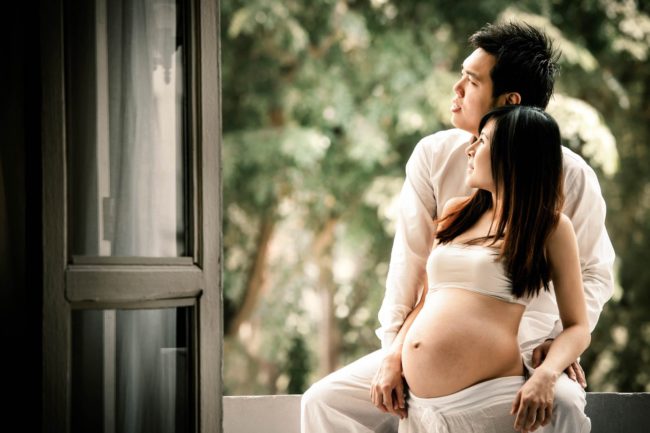 Maternity Photoshoot Singapore natural light and poses husband and wife with nature landscape background