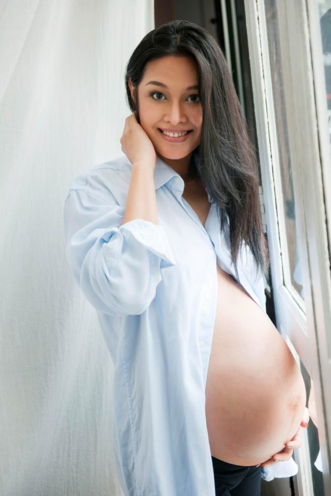 Maternity Photoshoot Singapore semi-nude pregnant mother casual portrait in light blue dress shirt