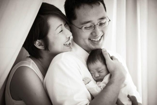 Newborn Shoot Singapore smiling father mother baby family black and white portrait