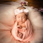 Newborn baby wrapped in swaddle photographed at White Room Studio natural light newborn photography studio, 219 River Valley Road, Singapore. Safe gentle newborn photoshoot 2026.