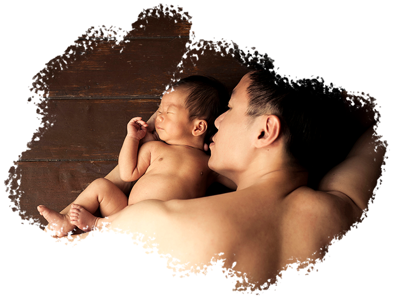 newborn-img2 Newborn Shoot Singapore father cradling and facing sleeping baby on wooden floors