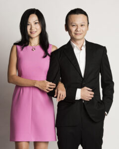 Couple photoshoot with a woman in pink dress and man in black suit, studio setting, natural light. White Room Studio Singapore