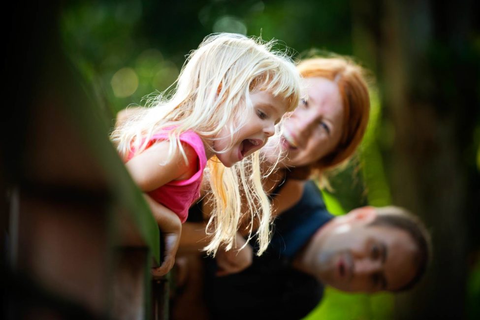 Family kids photography outdoor nature landscape session with young blonde child and parents smiling