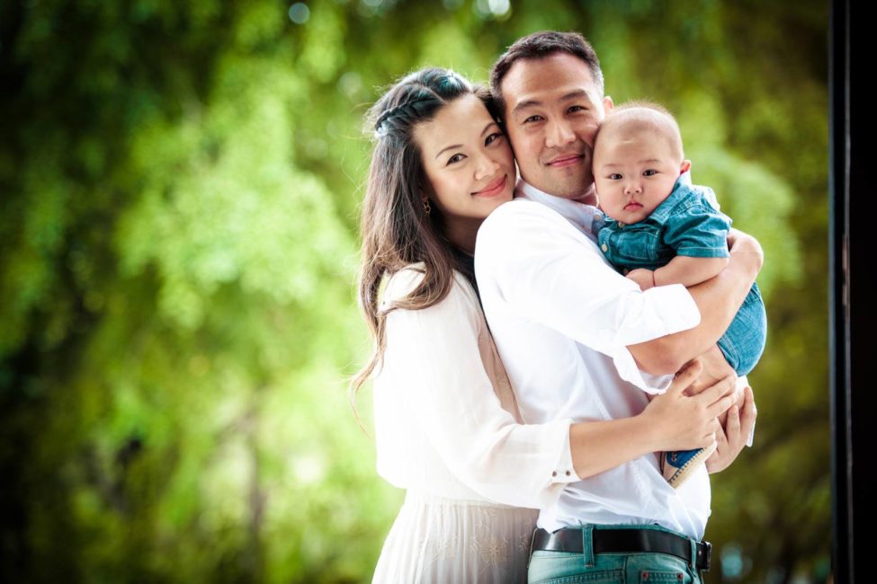 Family kids photography session mother hugging father and baby toddler with nature landscape in the background
