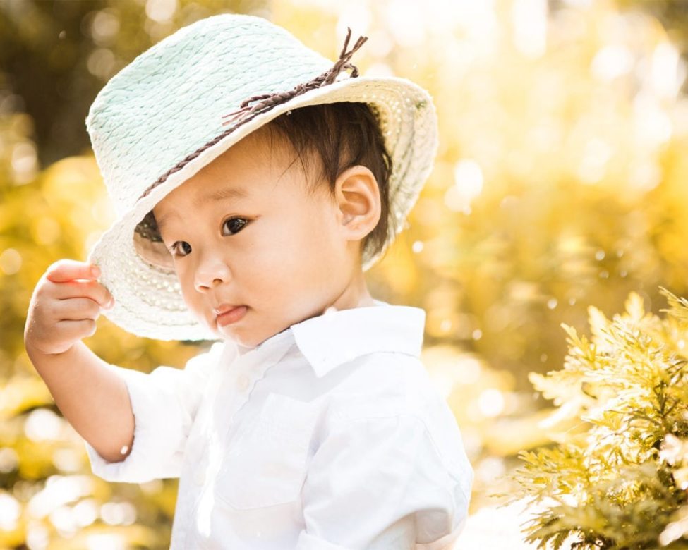 Family kids photography young boy toddler in a hat and white shirt with natural landscape background