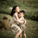 Children Outdoor Photoshoot Singapore sister and brother hugging at a park