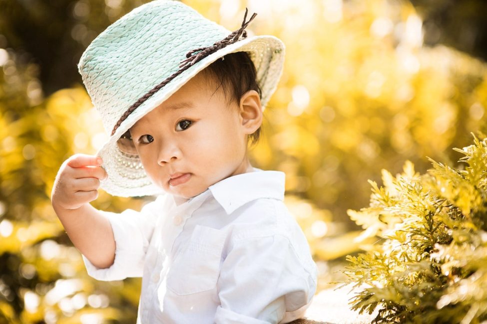 Kids Singapore Photography Outdoor young boy toddler in a hat and white shirt with natural landscape background