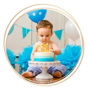 baby-icon copy First Year Baby Cake Smash Photography baby touching birthday cake with blue decorations in background