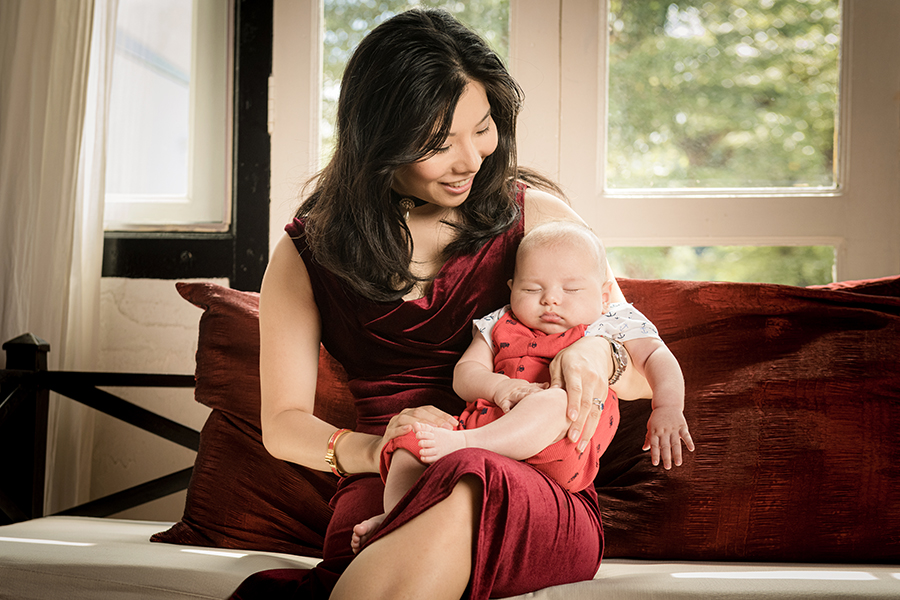 new mother with her 100 days old sleeping baby in peranakan shophouse white room studio