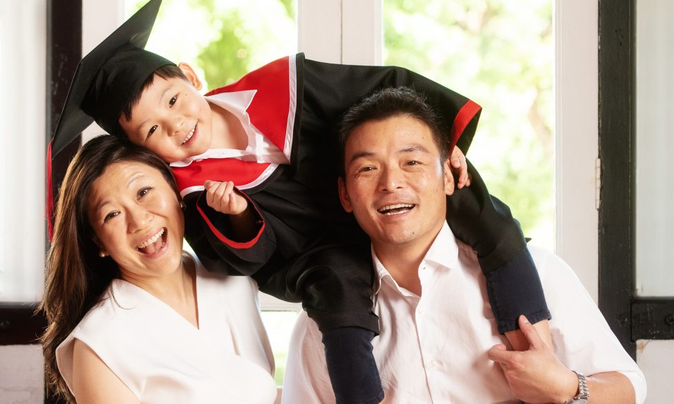 family kindergarten K2 graduation photoshoot in gown at white room studio
