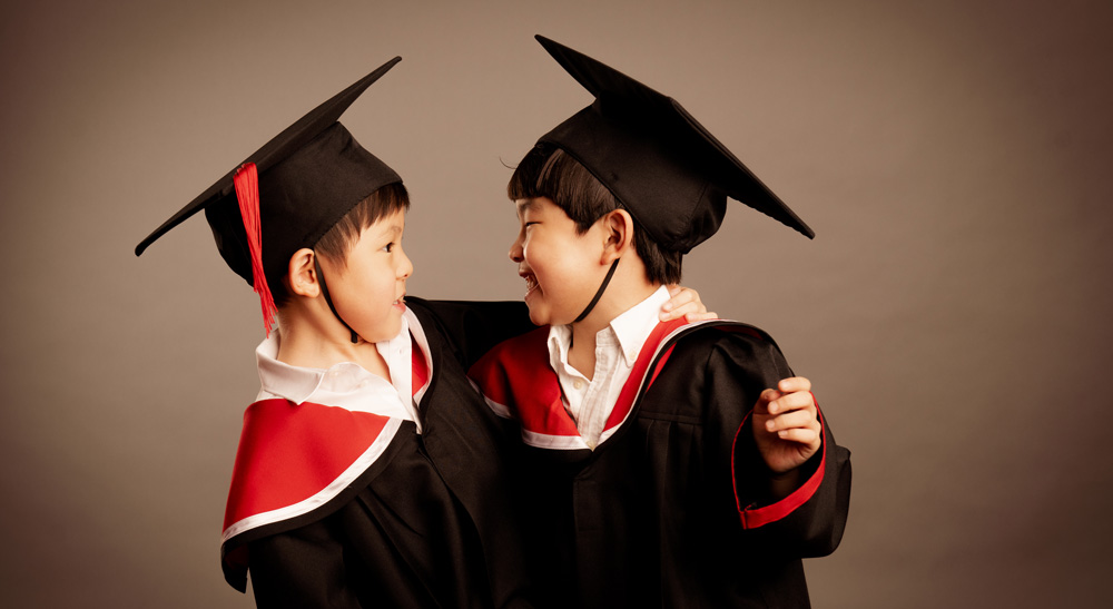 k2-kindergarten-photoshoot-singapore-05 Two kids dressed in K2 graduation and cap during K2 Graduation photoshoot in Singapore, White Room Studio. Credit: White Room Studio Pte Ltd