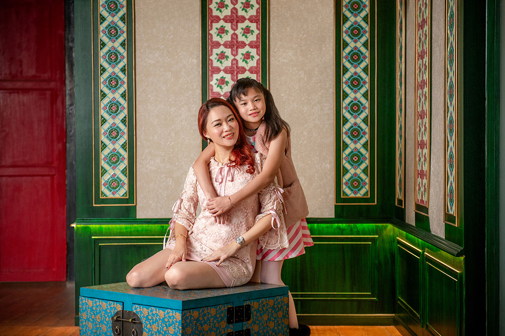 Family in Peranakan outfits during a family photoshoot at White Room Studio, Singapore