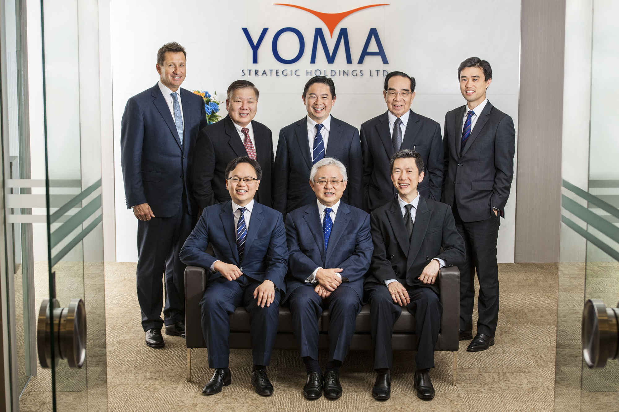 Group photo of business professionals from Cogent Communications Yoma Singapore during a professional company photoshoot in an office setting Credit: White Room Studio