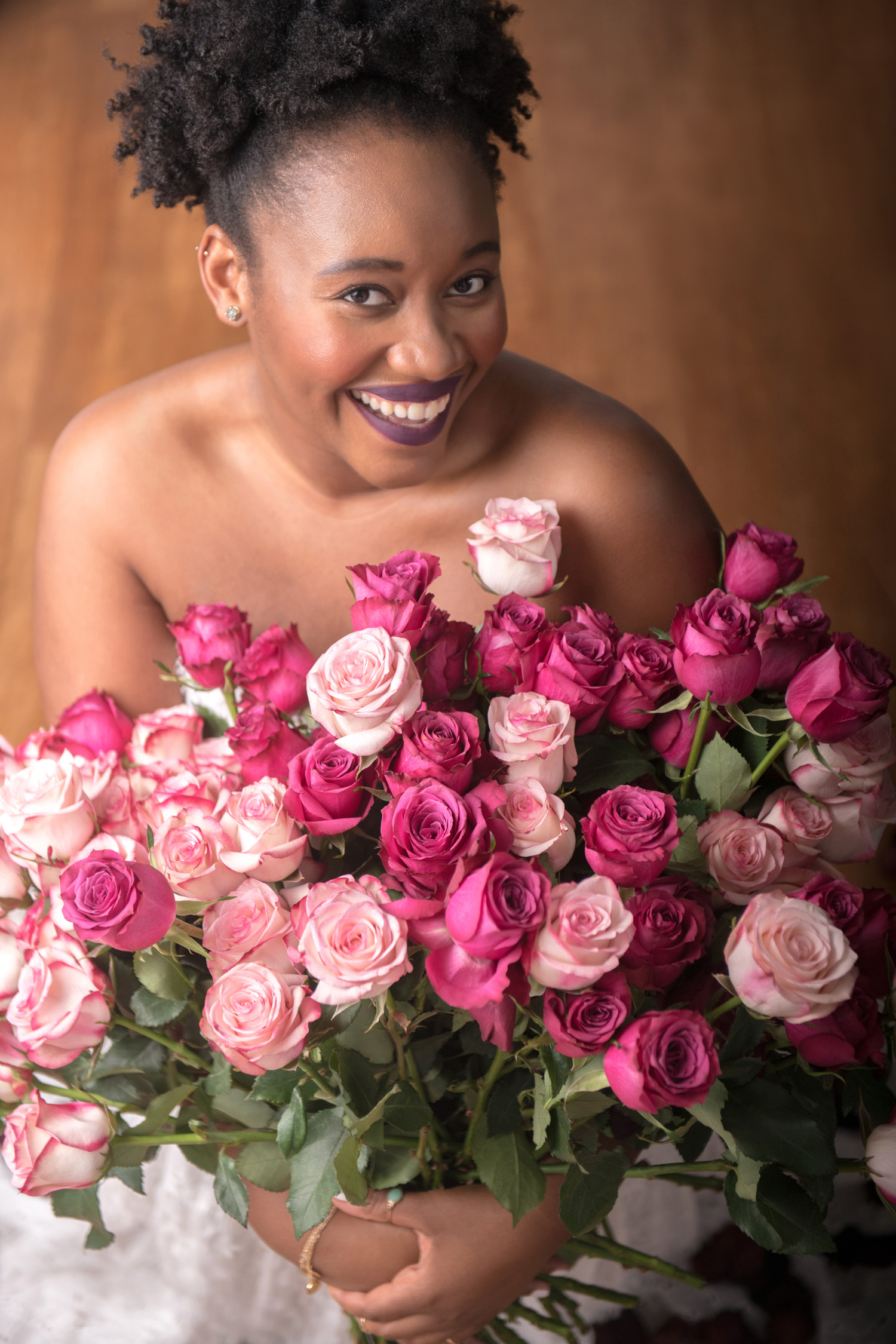 Woman posing for personal portrait with flowers in a photography studio setting during a personal branding photoshoot in Singapore, White Room Studio. Credit: White Room Studio Pte Ltd