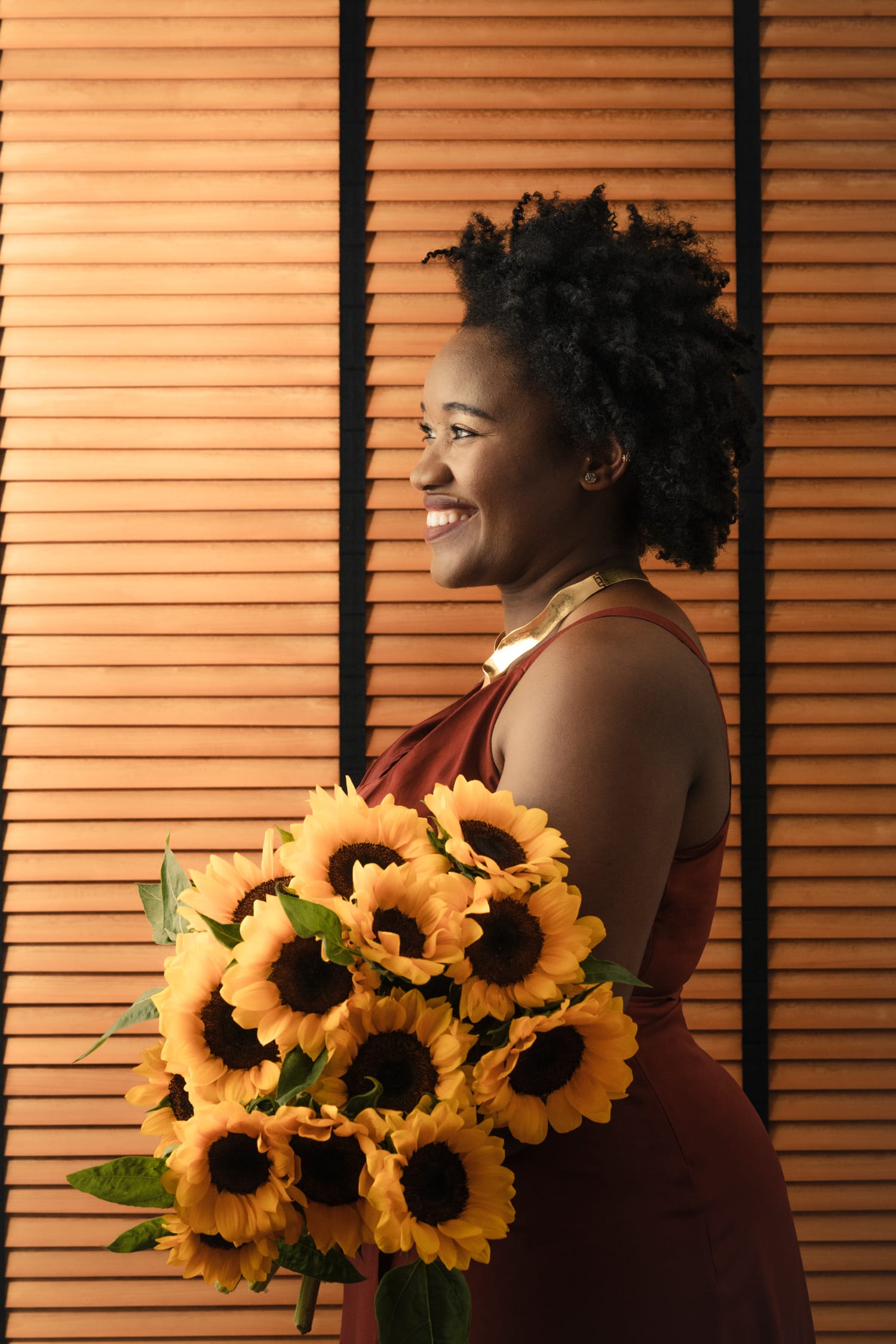 Woman posing for candid portrait with flowers in a photography studio setting during a personal branding photoshoot in Singapore, White Room Studio. Credit: White Room Studio Pte Ltd