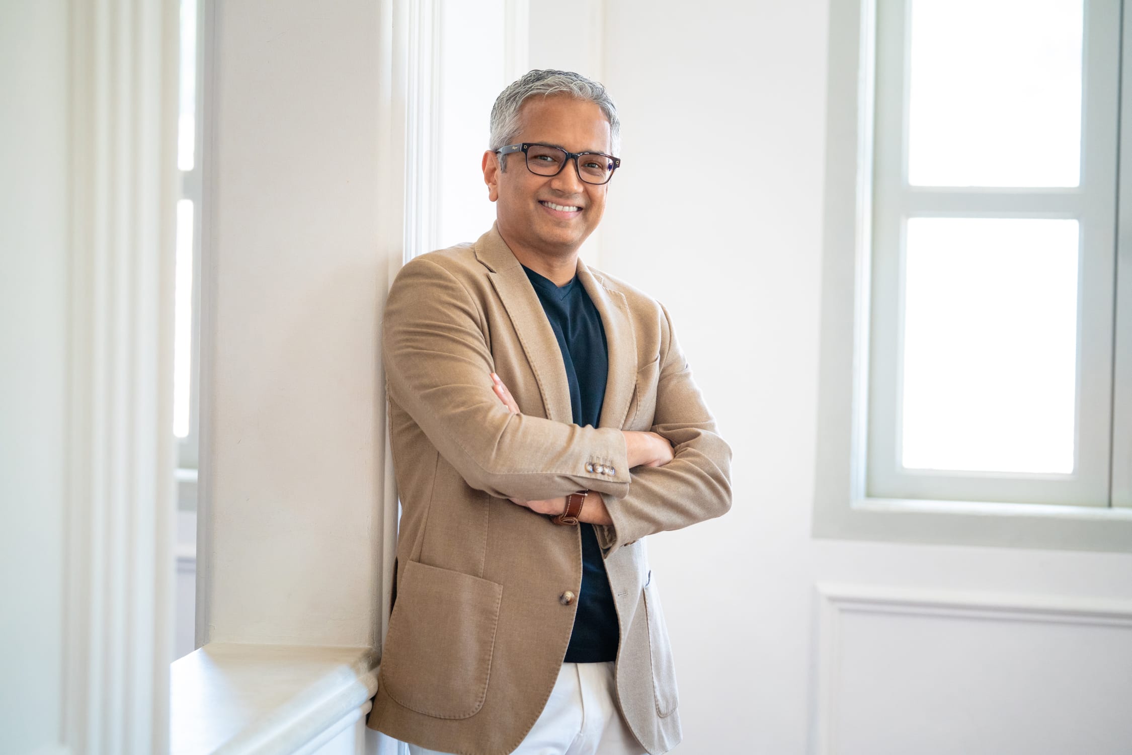 Professional Corporate & Company Photoshoot in Photography Studio, Singapore Businessman posing for professional LinkedIn headshot in a photography studio setting during a corporate photoshoot in Singapore, White Room Studio. Credit: White Room Studio Pte Ltd