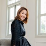 Woman posing for professional headshot in a photography studio setting during a corporate photoshoot in Singapore. Hair & makeup services provided by White Room Studio. Credit: White Room Studio Pte Ltd