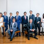 A team of male and female professionals posing for a group corporate photoshoot in Singapore, White Room Studio Credit: White Room Studio
