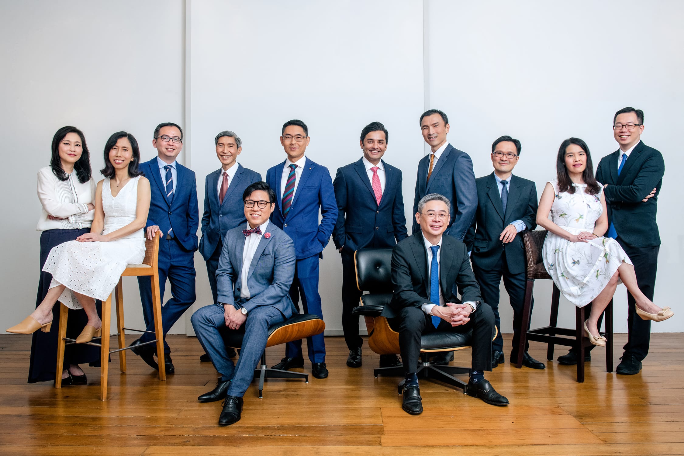 A team of male and female professionals posing for a group corporate photoshoot in Singapore, White Room Studio Credit: White Room Studio